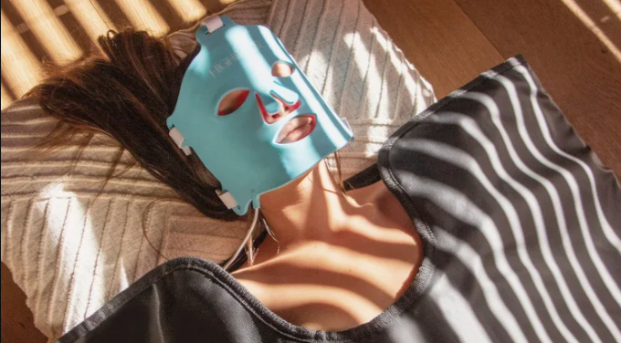 Lady wearing red light therapy mask